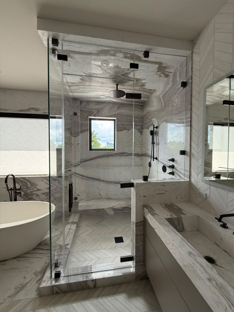 Completed custom glass shower enclosure viewed across the bathroom